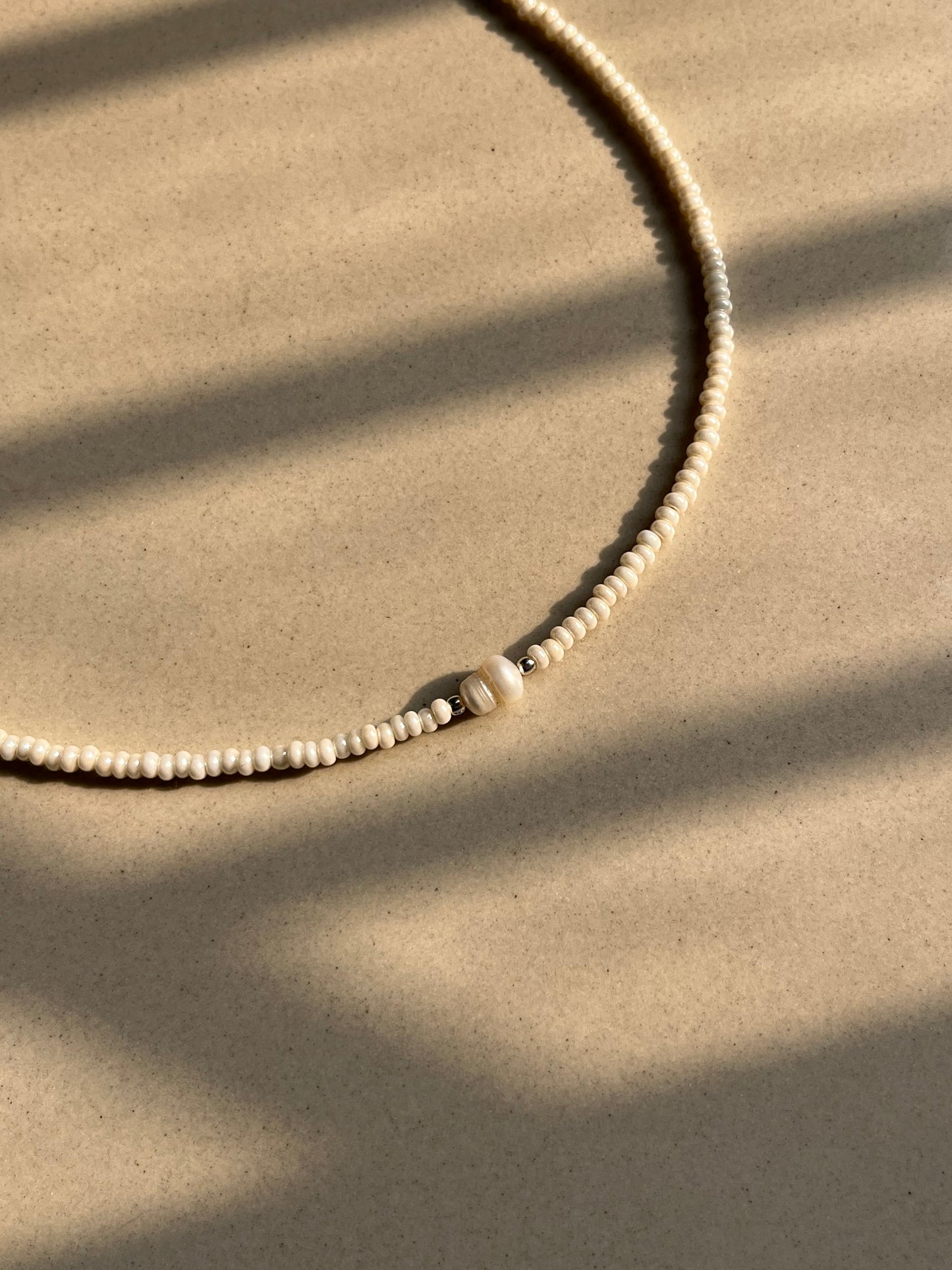 Off centre pearl beaded necklace
