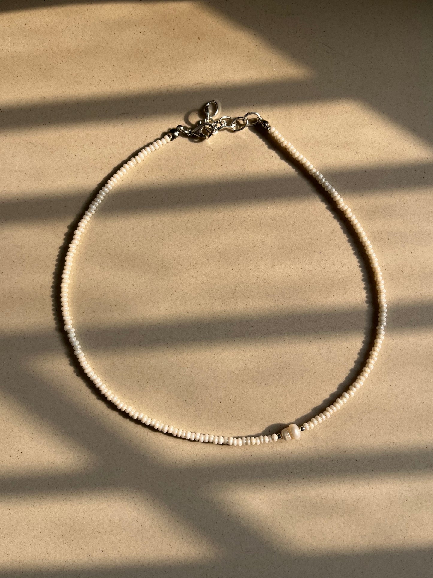 Off centre pearl beaded necklace